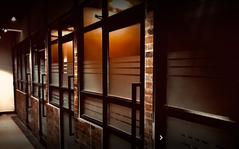 PCS Businesscentre private office cabins – glass-front cabin corridor in Vijayawada